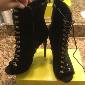 Black lace up peep toe heeled booties.
